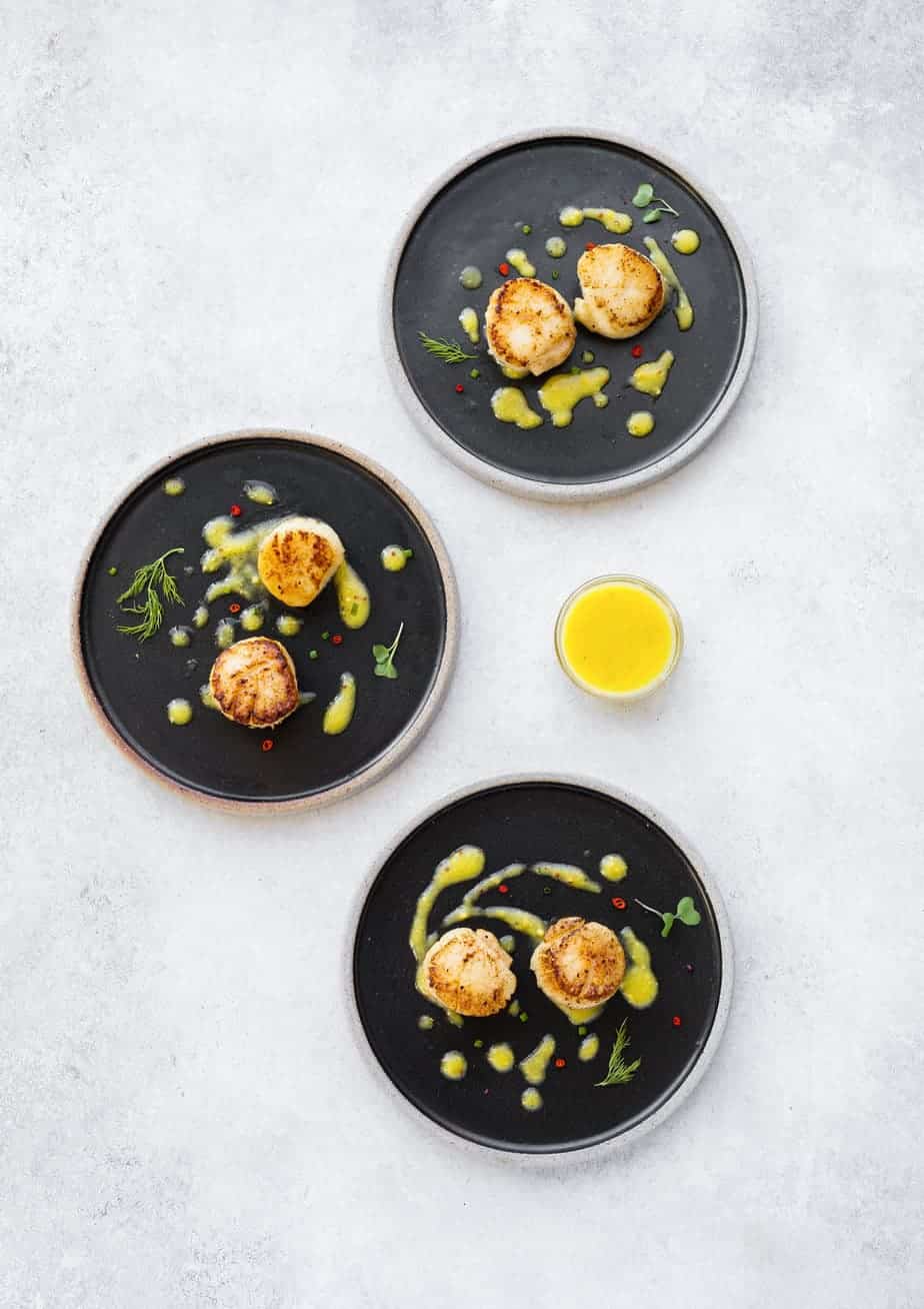 Looking for seafood appetizer recipes? Try these pan seared scallops, served with a tangy mango vinaigrette recipe. It’s a great food and wine pairing recipe for your next party or special night.