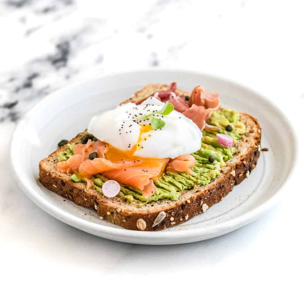 Smashed Avocado on Toast with Egg, Smoked Salmon, and Prosciutto