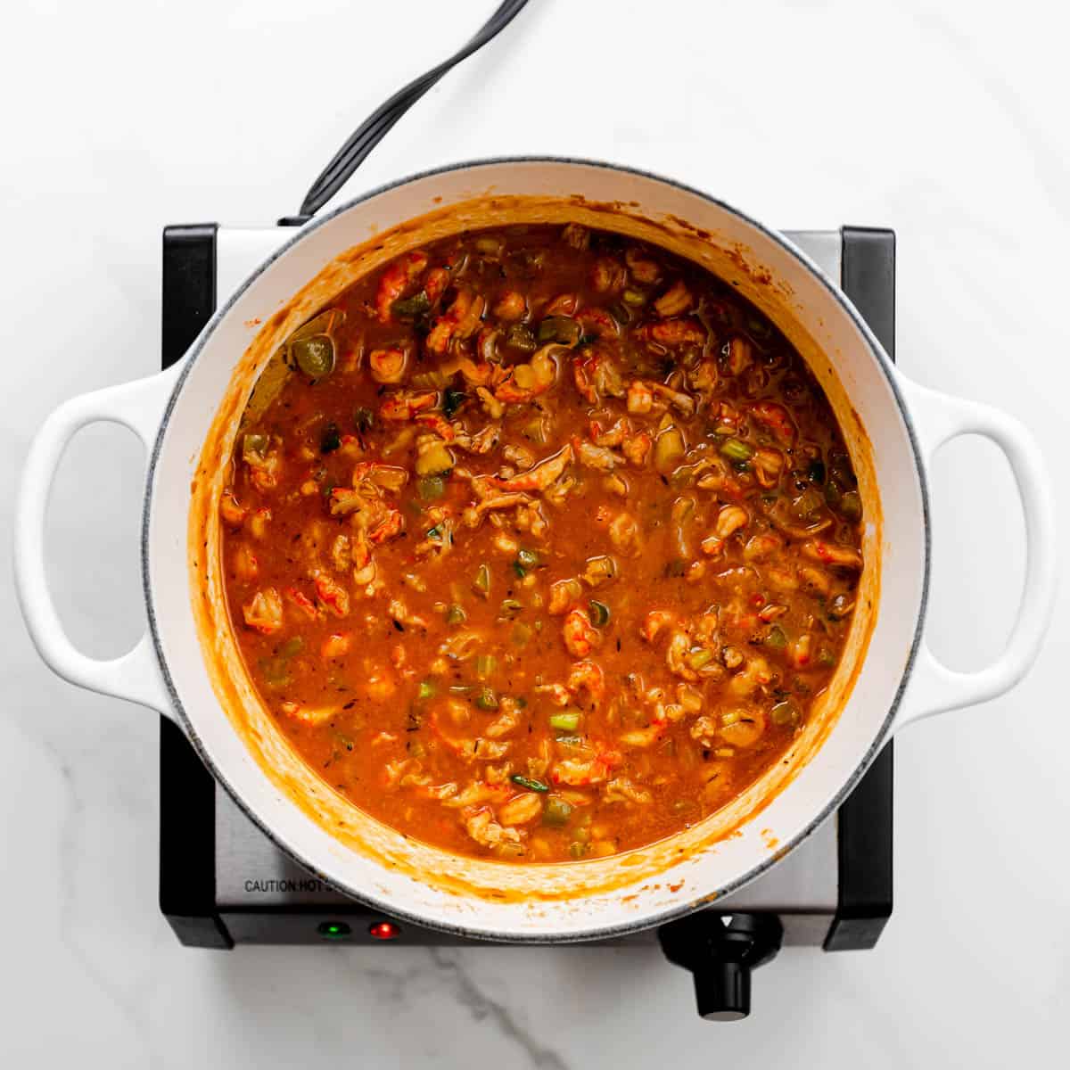 Add crawfish into the pot and let the mixture simmer for 4 minutes or until the meat is warm thoughout, stirring occasionally. 