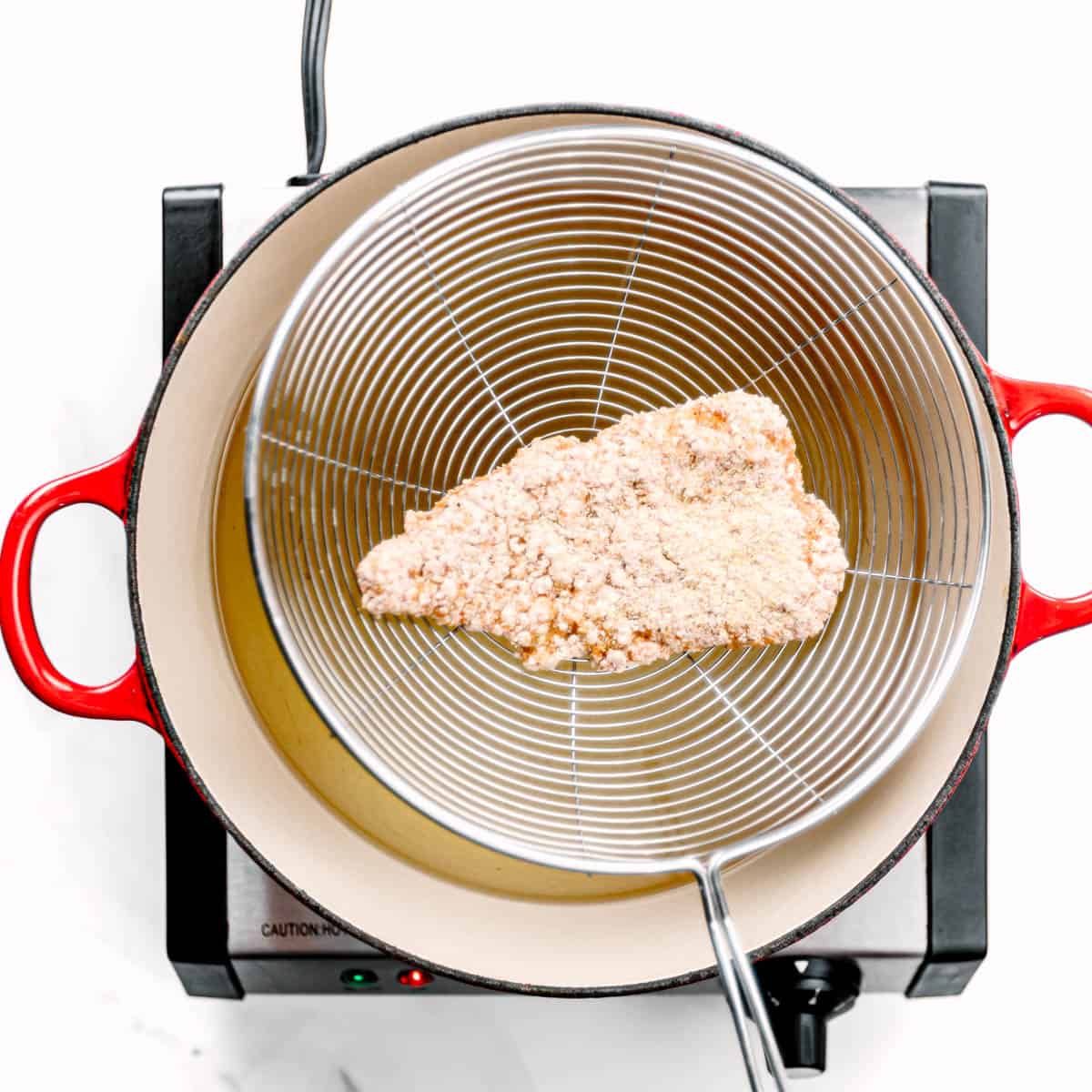 In a large heavy-bottomed pan or pot, heat about 3 inches of oil over moderately high heat to 350°F. 