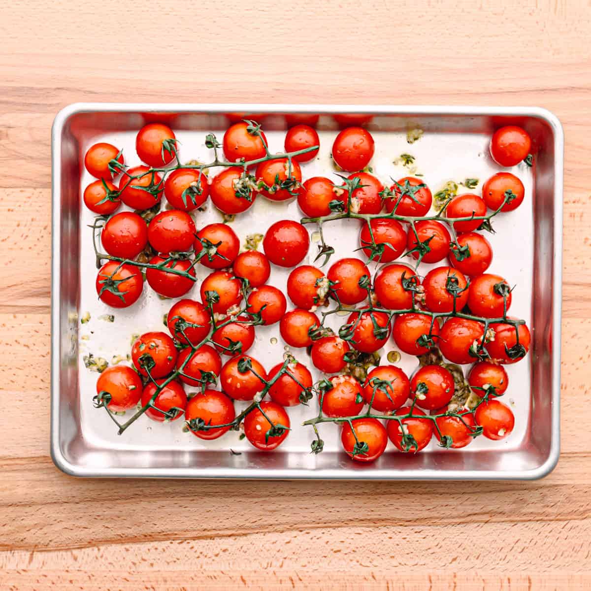 Place the tomatoes on a baking sheet then drizzle with the oil mixture.