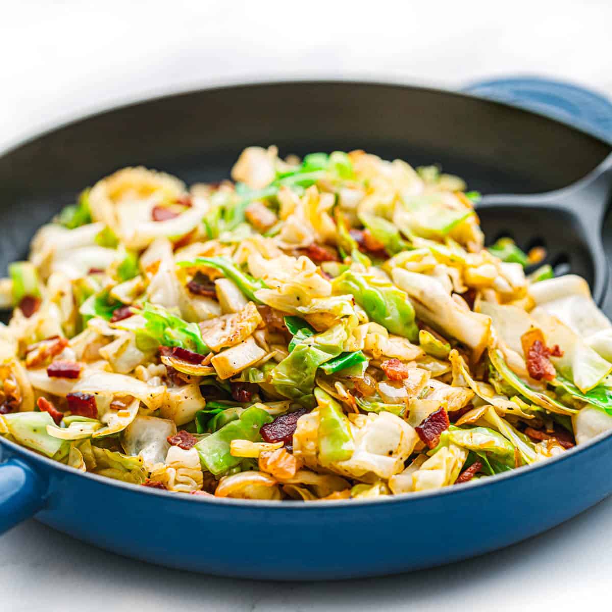 fried cabbage with bacon and onions.