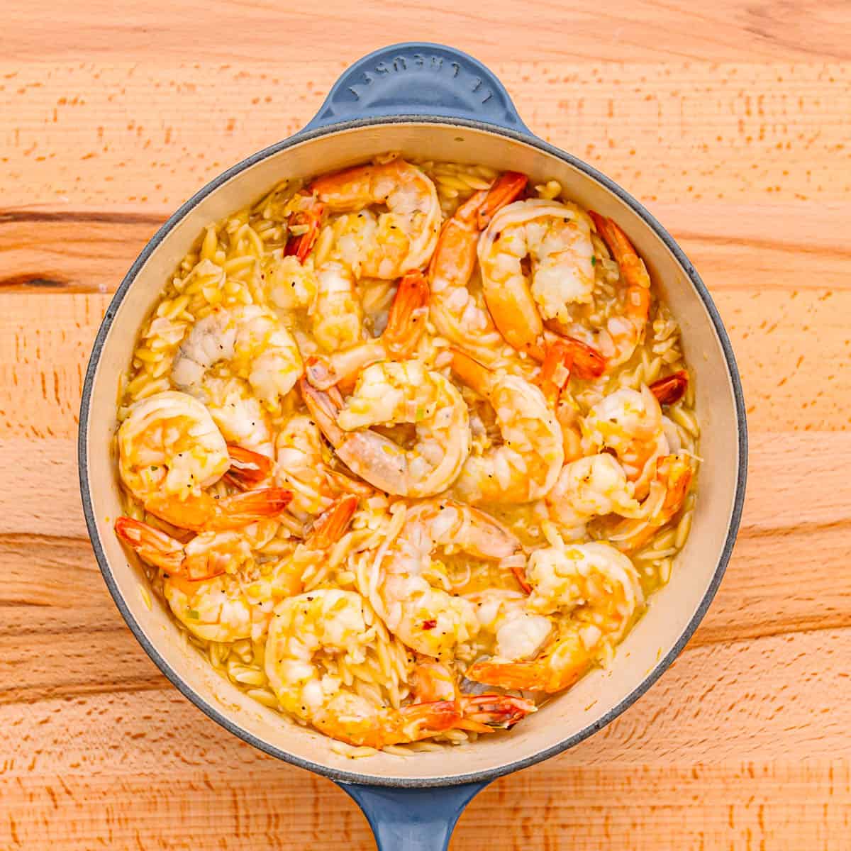Put the lid back on and continue cooking until the shrimp is fully cooked and the orzo is tender. 
