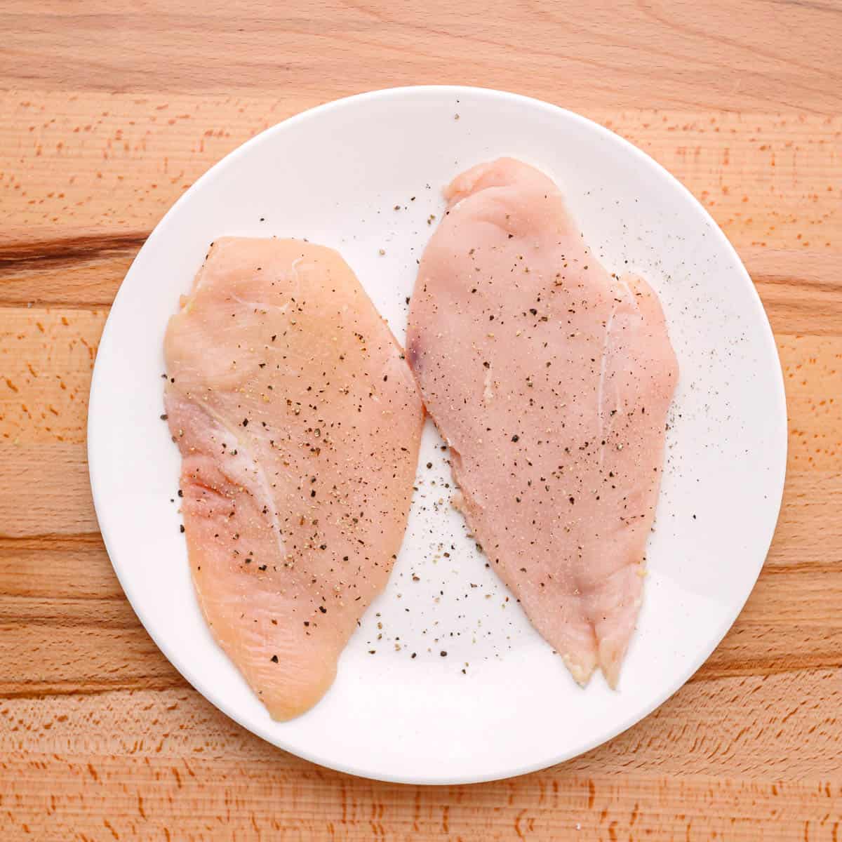 season chicken breasts with salt and pepper.