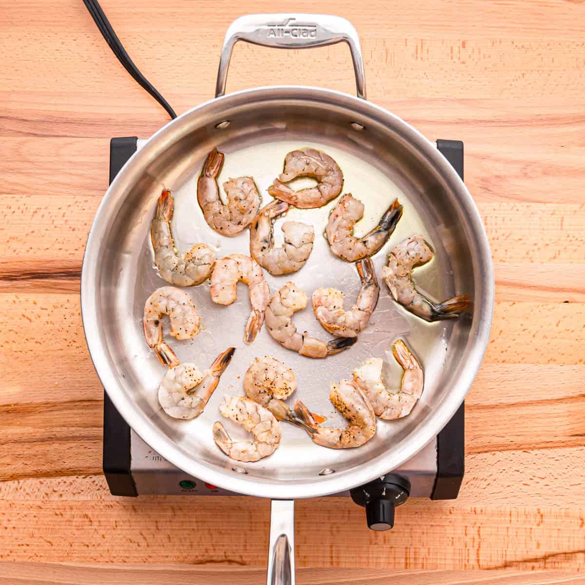 In a skillet heat oil over medium-high heat

Add the seasoned shrimp and cook them until they turn pink. This process usually takes about 2-3 minutes. Be careful not to overcook them, as shrimp can become tough if cooked for too long.