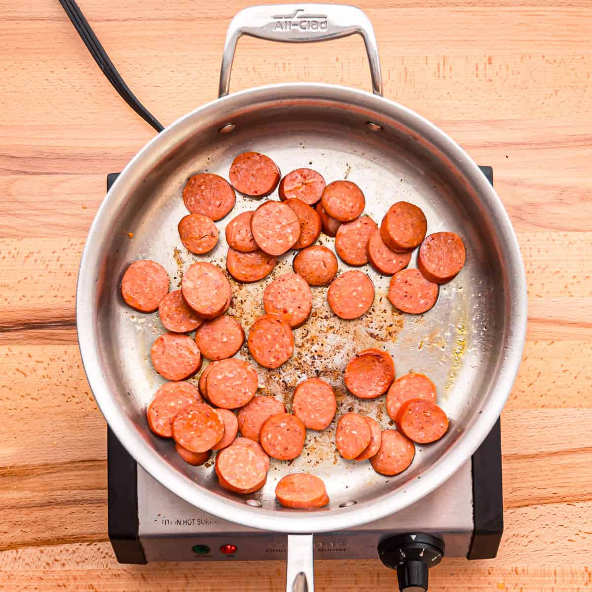 After removing the shrimp from the skillet, continue by browning the sausage for about 1-2 minutes.