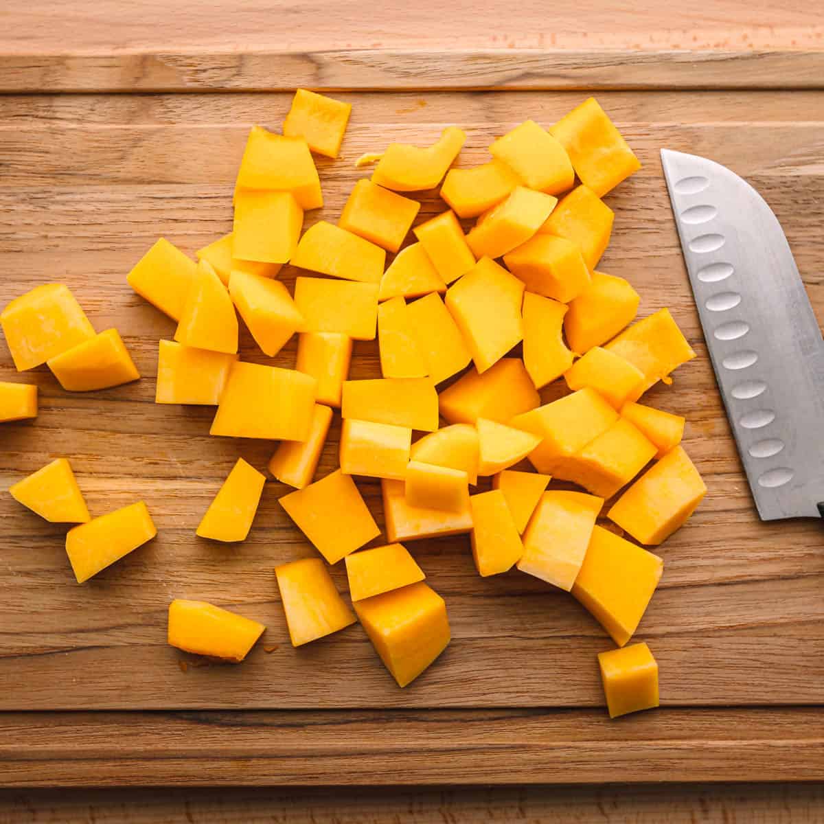 Dice the butternut squash into consistent cubes and place them in a spacious bowl.