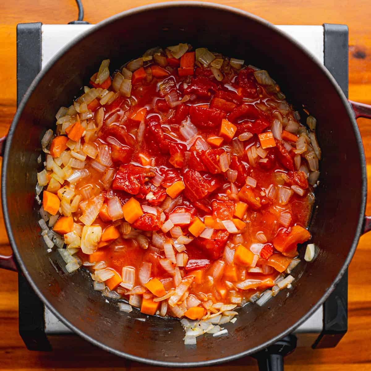 Add diced tomatoes, stir well, and simmer for 1 minute.