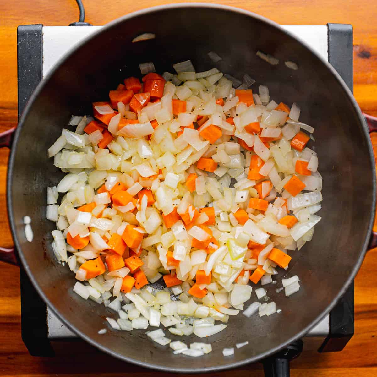 Add the diced onion and carrots, sauté for 4 minutes or until slightly softened.