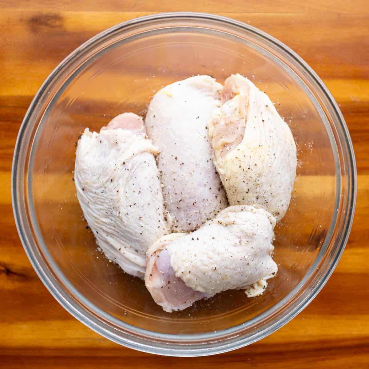 Season the chicken thighs with salt and black pepper.