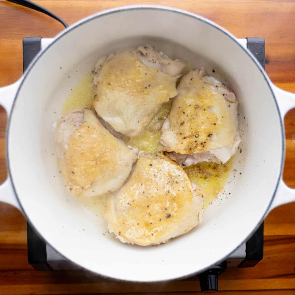 Heat oil in a large Dutch oven; cook the chicken until brown on all sides. Transfer the browned chicken to a plate.