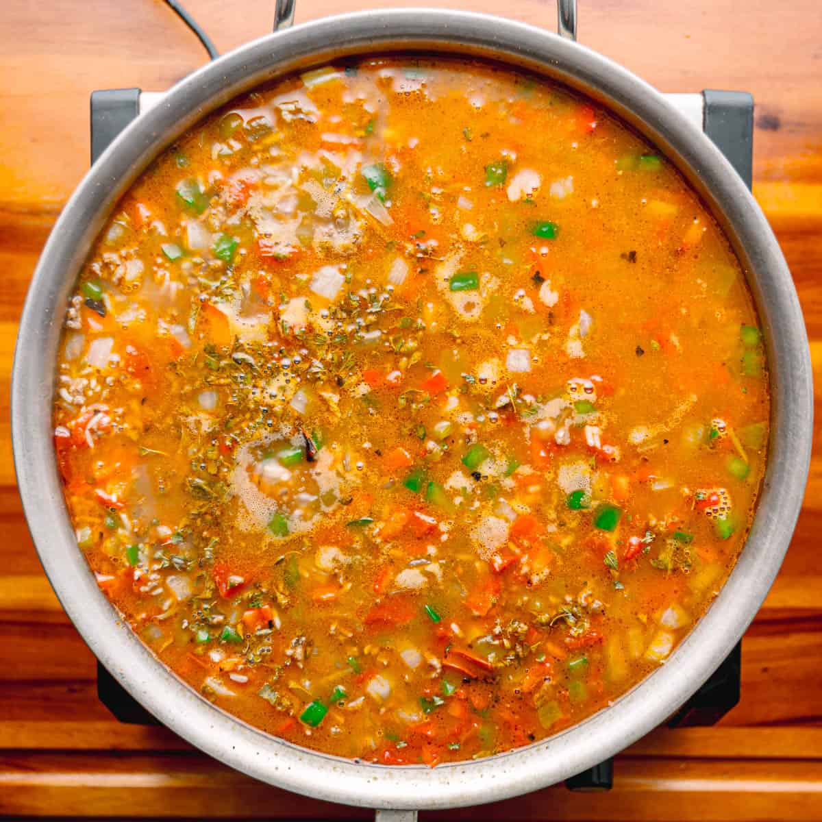 Pour in broth and bring to a boil over medium-high heat 