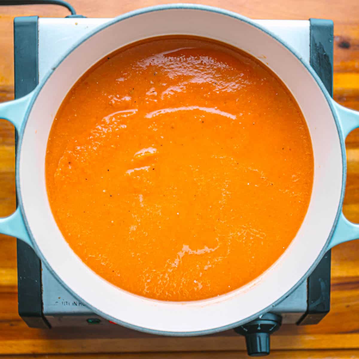 In a pot, combine the puree with broth.