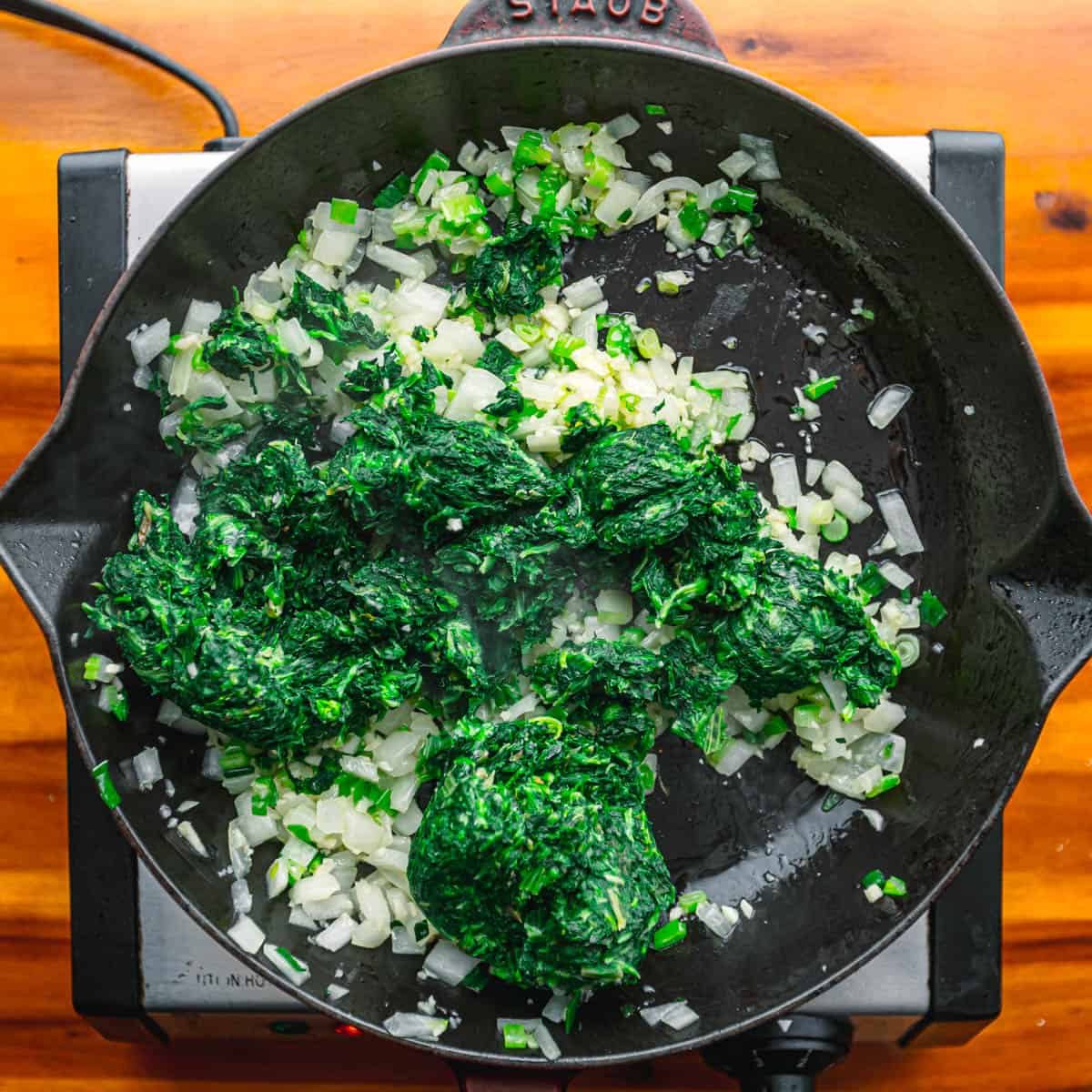 Add garlic and stir until fragrant. Incorporate spinach and stir for 2 minutes. 