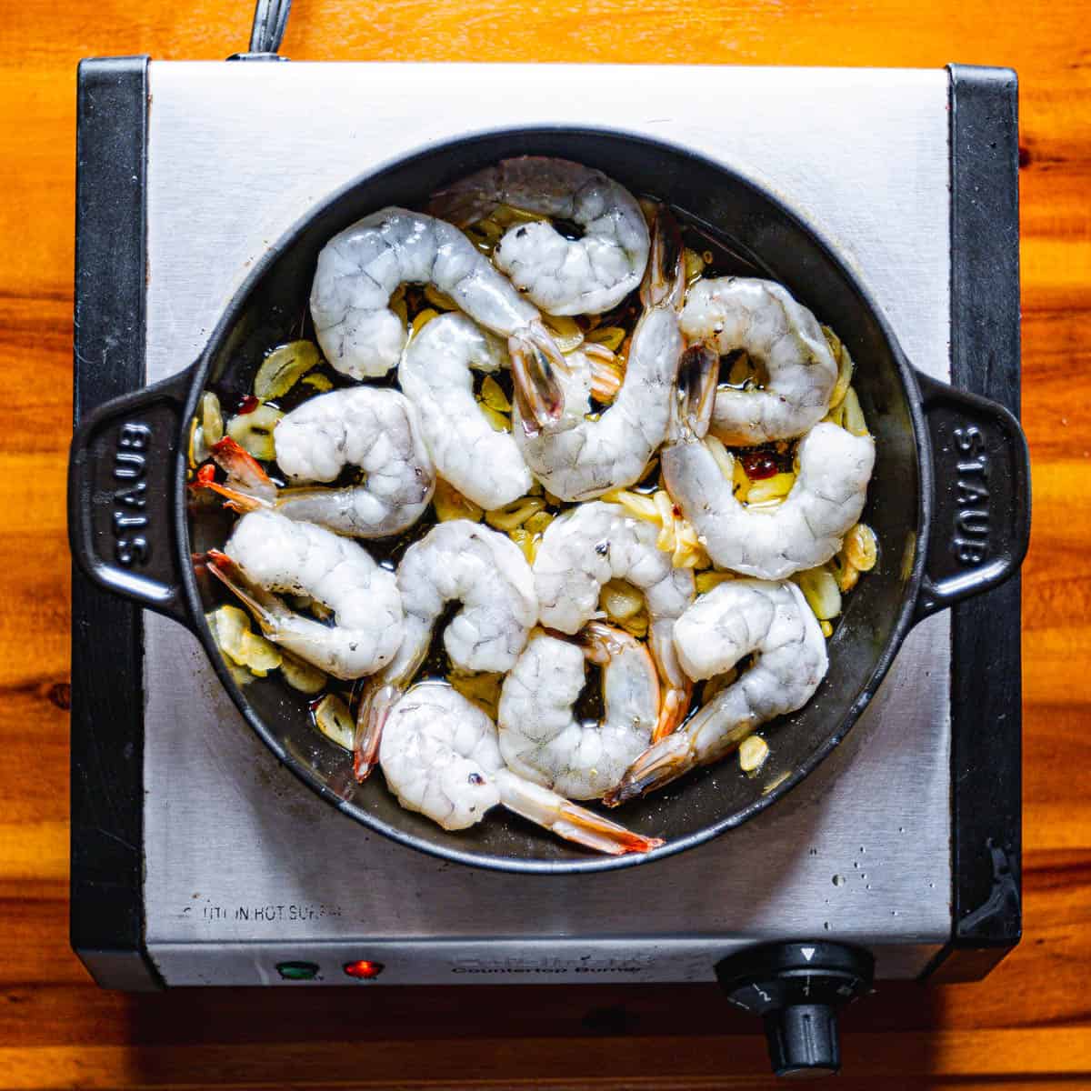 Cook the shrimp over medium heat until they are barely pink, turning often to ensure even cooking.