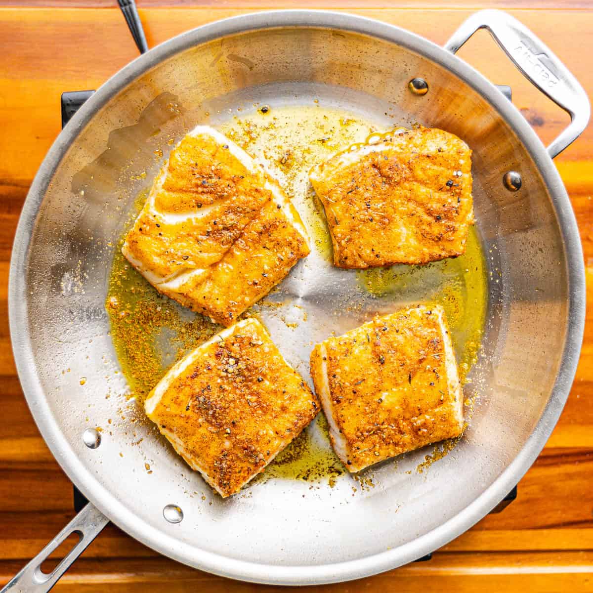 Heat oil in a skillet over medium-high heat. Once hot, add the cod fillets and cook until they turn golden brown and are cooked through, about 3-4 minutes per side.