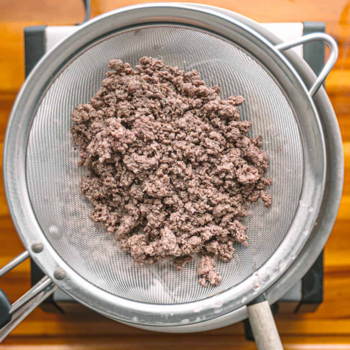 draining brown ground beef.