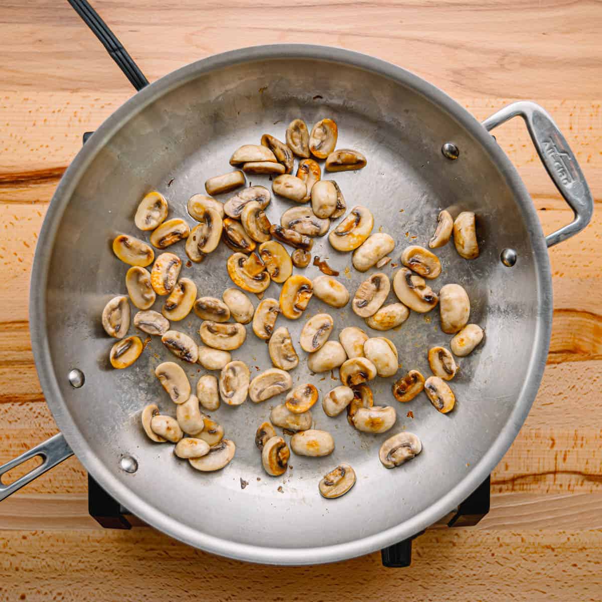 Heat some oil in there over medium-high heat. Toss in your mushrooms and let them sizzle away for about 4 minutes 