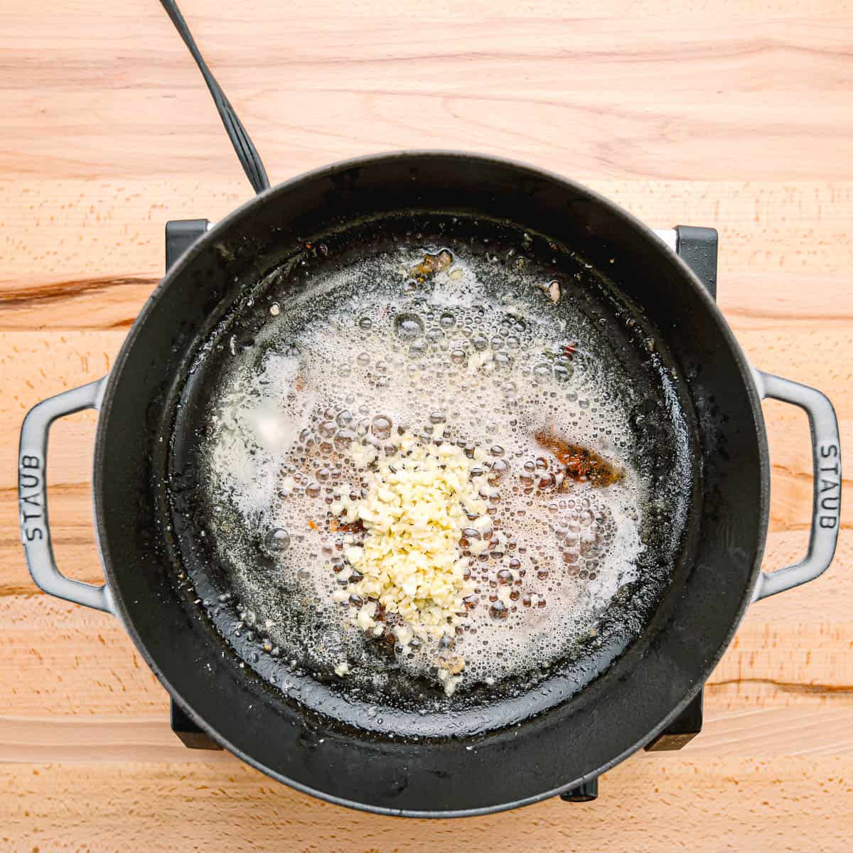 Add butter and garlic to the skillet, stirring until fragrant.