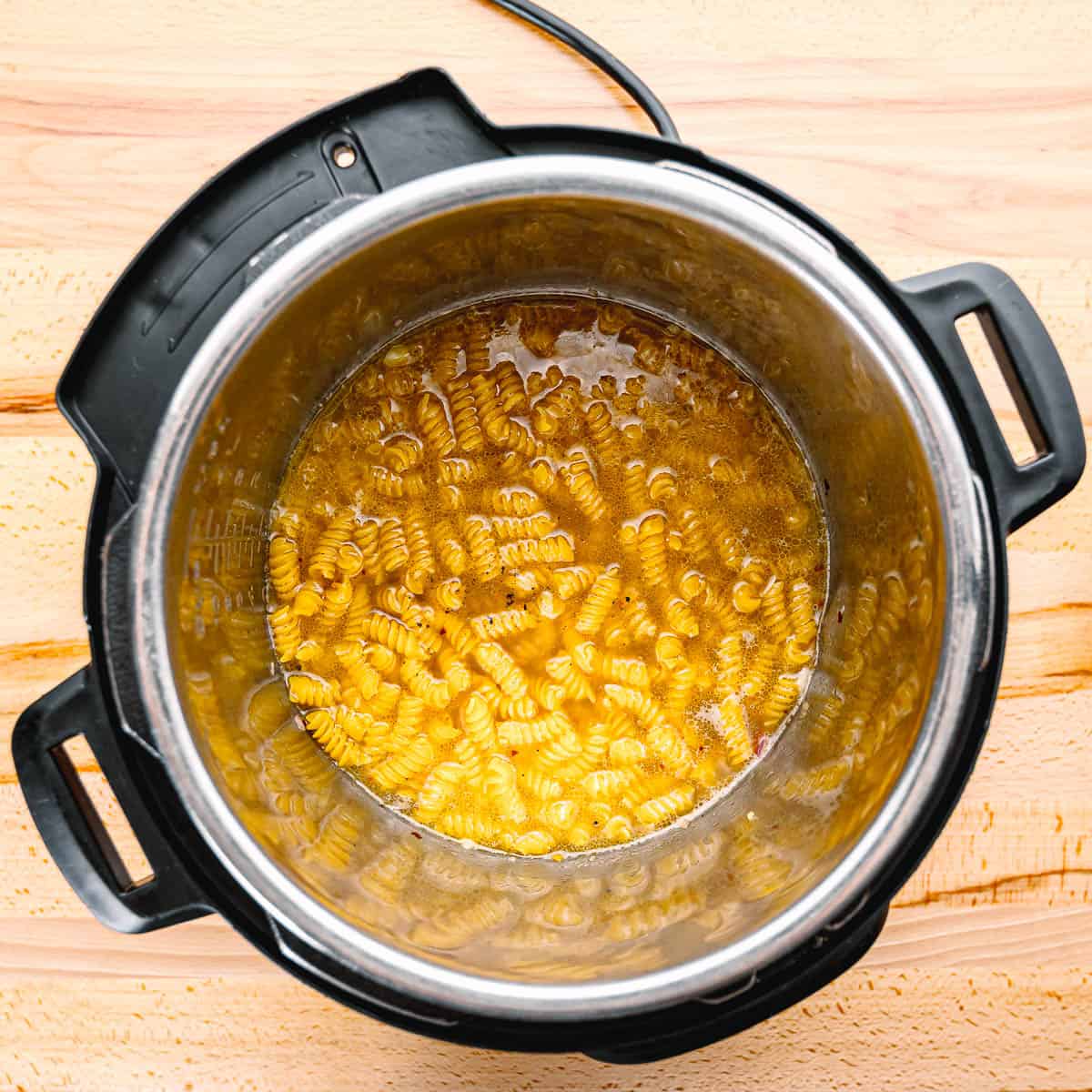 adding pasta in an instant pot. 