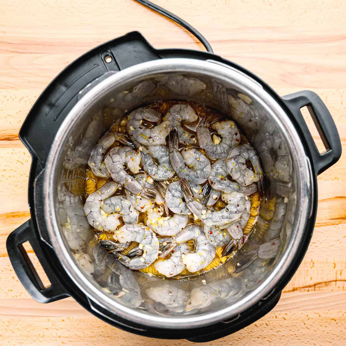 adding shrimp in an instant pot. 