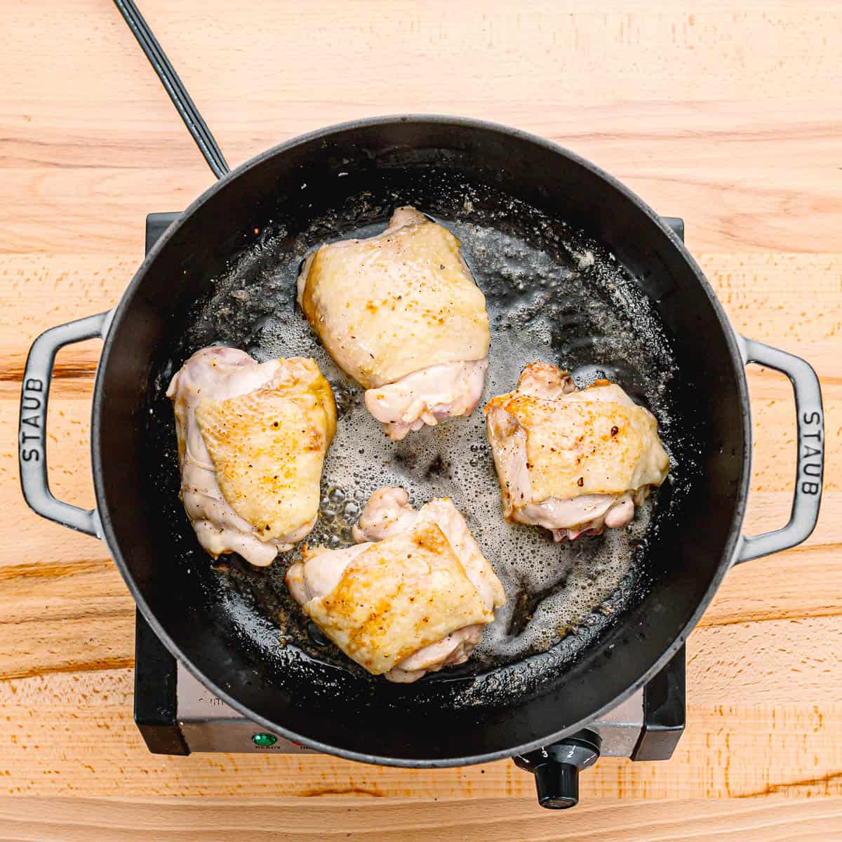 Start by seasoning the chicken legs and thighs with salt and black pepper.