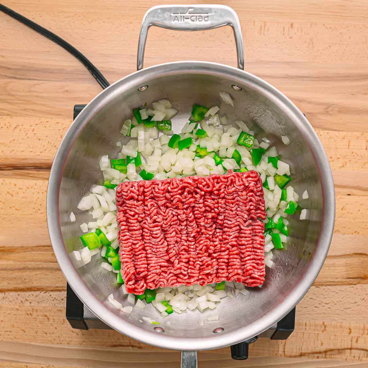 Add the ground beef to the pot and cook for about 5 minutes, breaking it up as it cooks.