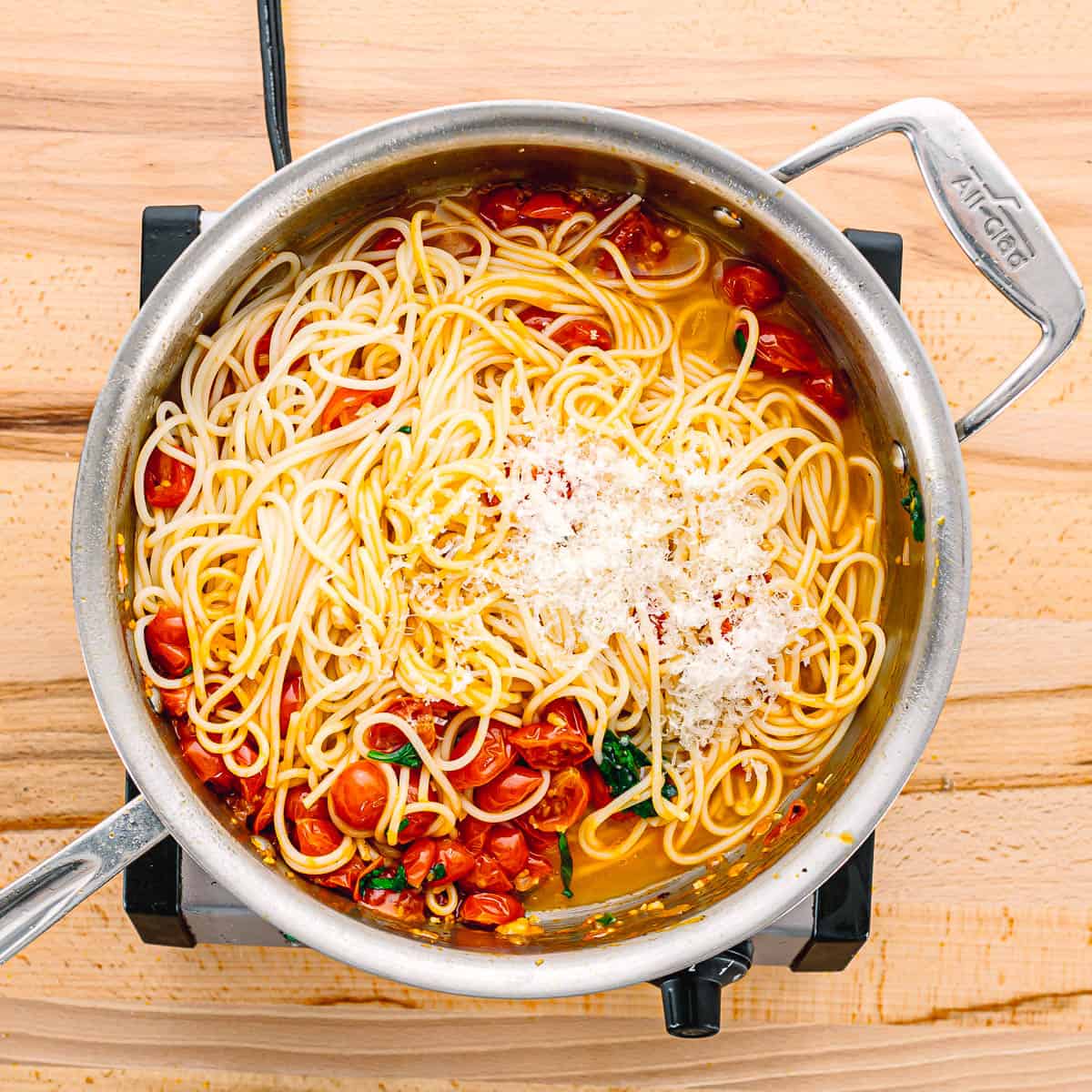 Add the drained pasta to the skillet. Toss in the fresh basil and reserved pasta water, stirring well to combine everything. Gradually stir in the Parmesan cheese until melted and incorporated into the sauce.