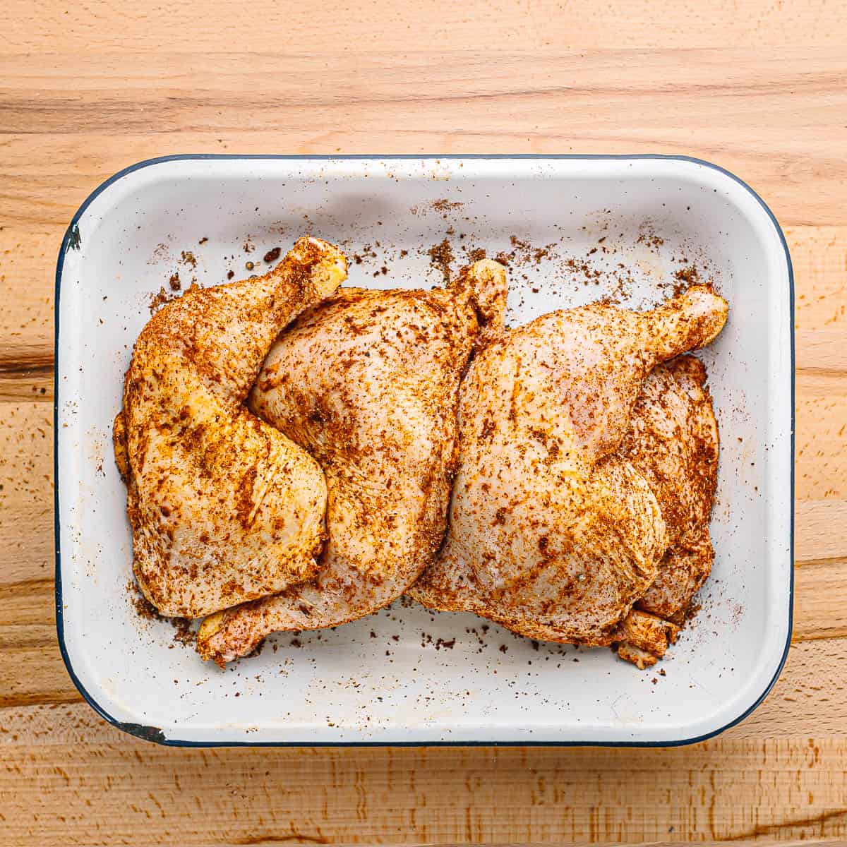 Pat the chicken leg quarters dry with paper towels. Season them with paprika, garlic powder, salt, and black pepper. Let them marinate in the refrigerator for at least 15 minutes.