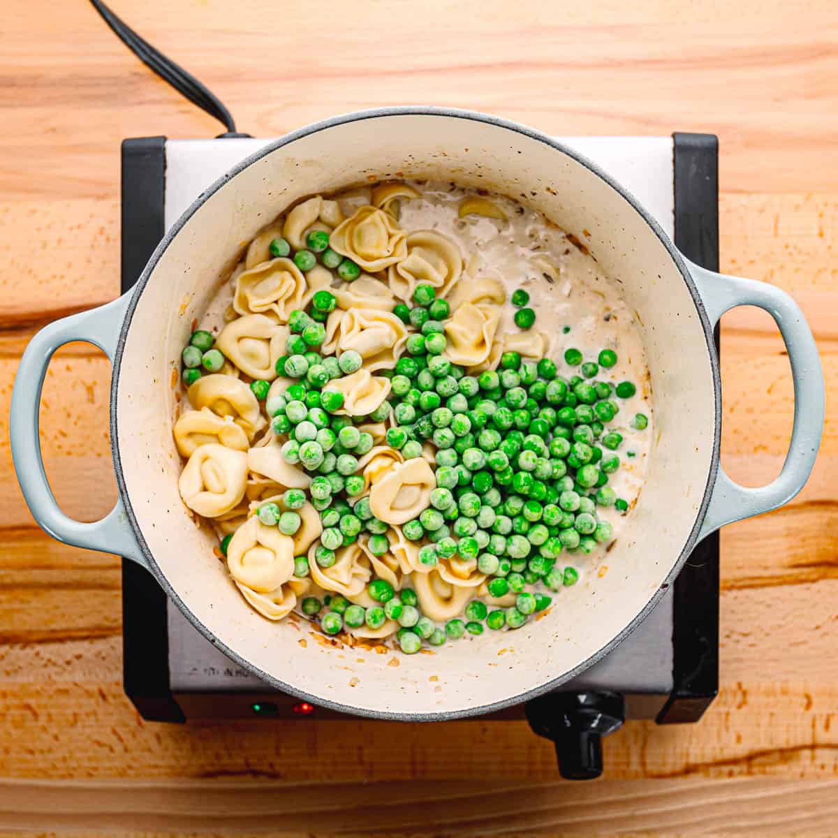 cooking tortellini with peas.