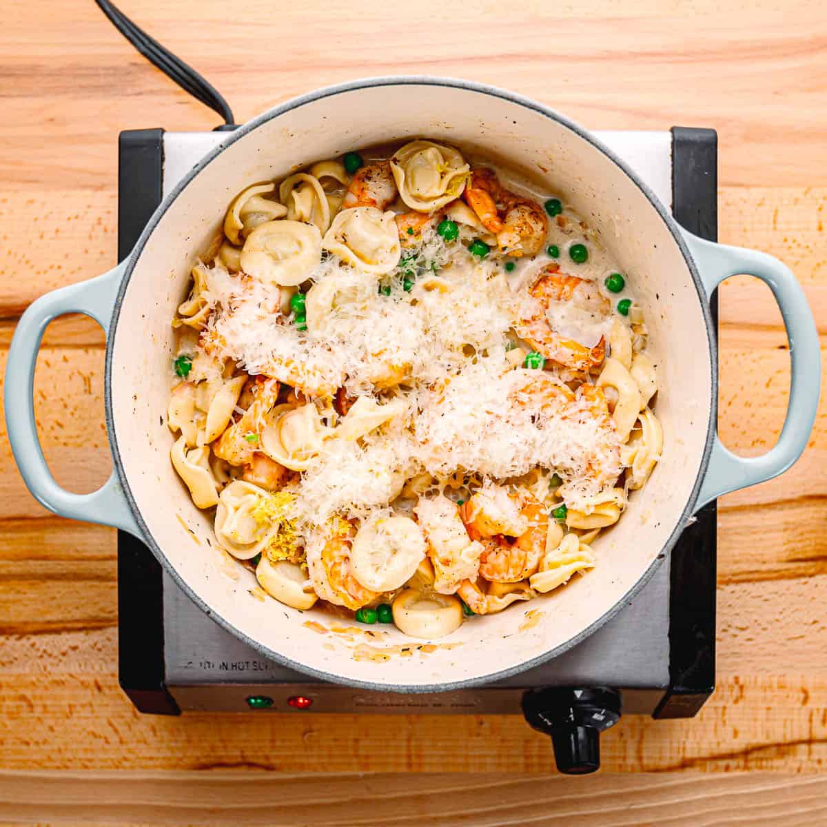 cooking tortellini, peas, and shrimp.