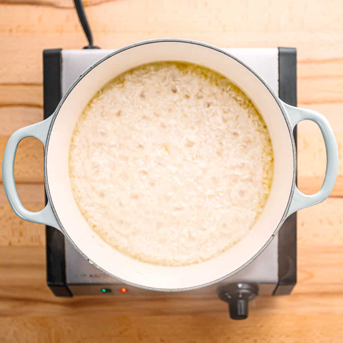 cooking rice on the stove. 