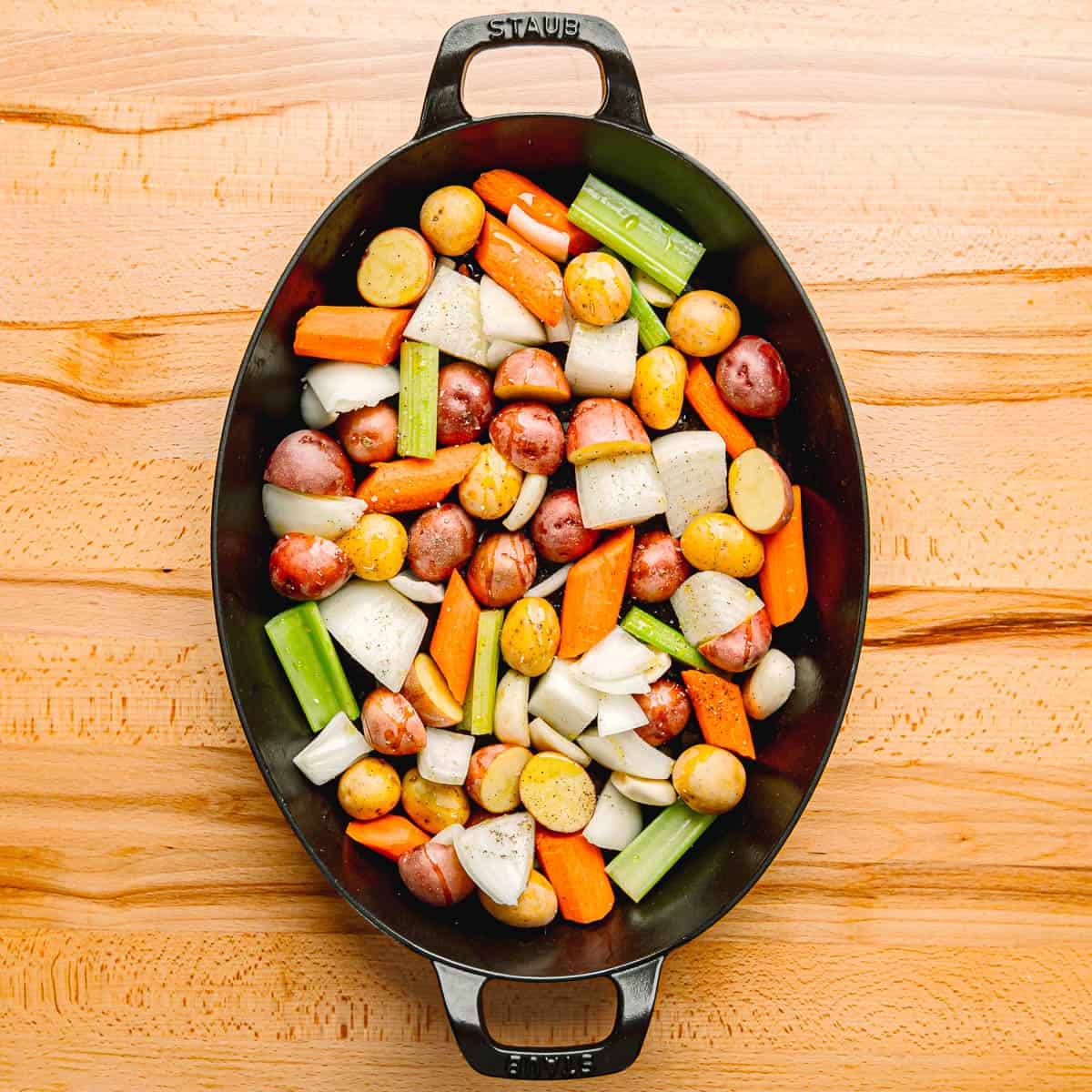 preparing vegetables in a pan for roasting.