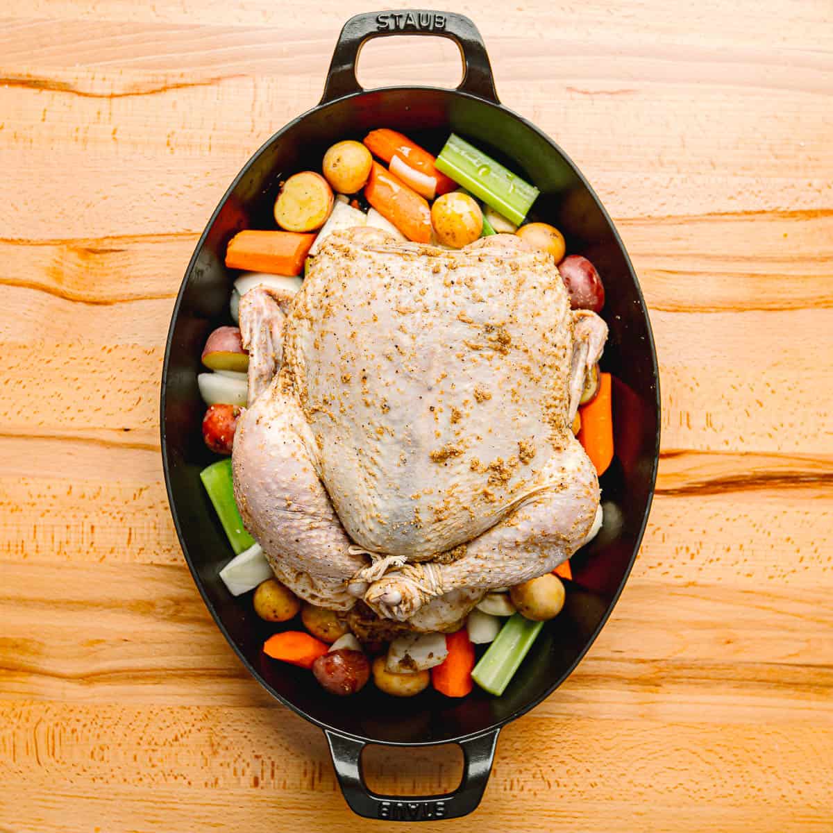 chicken and vegetables in a roasting pan.