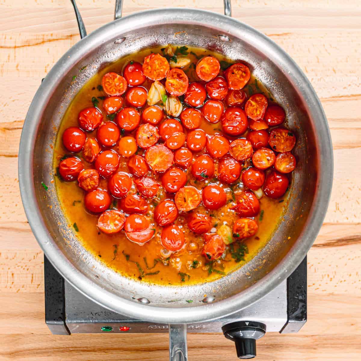 adding wine to tomatoes.