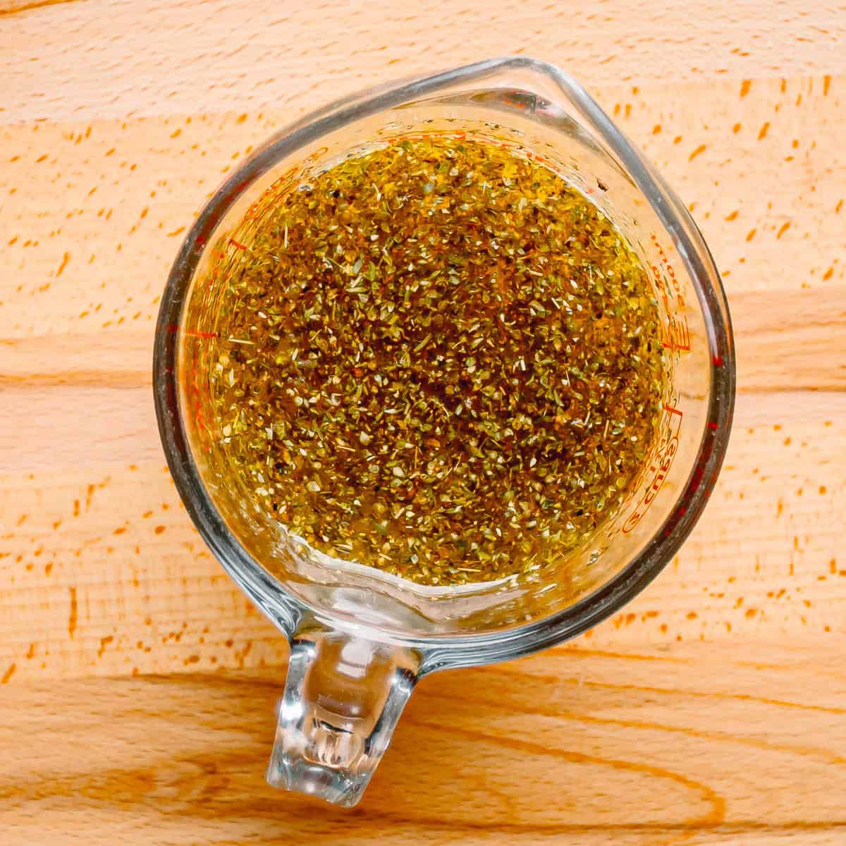 Bowl of Greek Lemon Potato marinade made with olive oil and lemon juice.