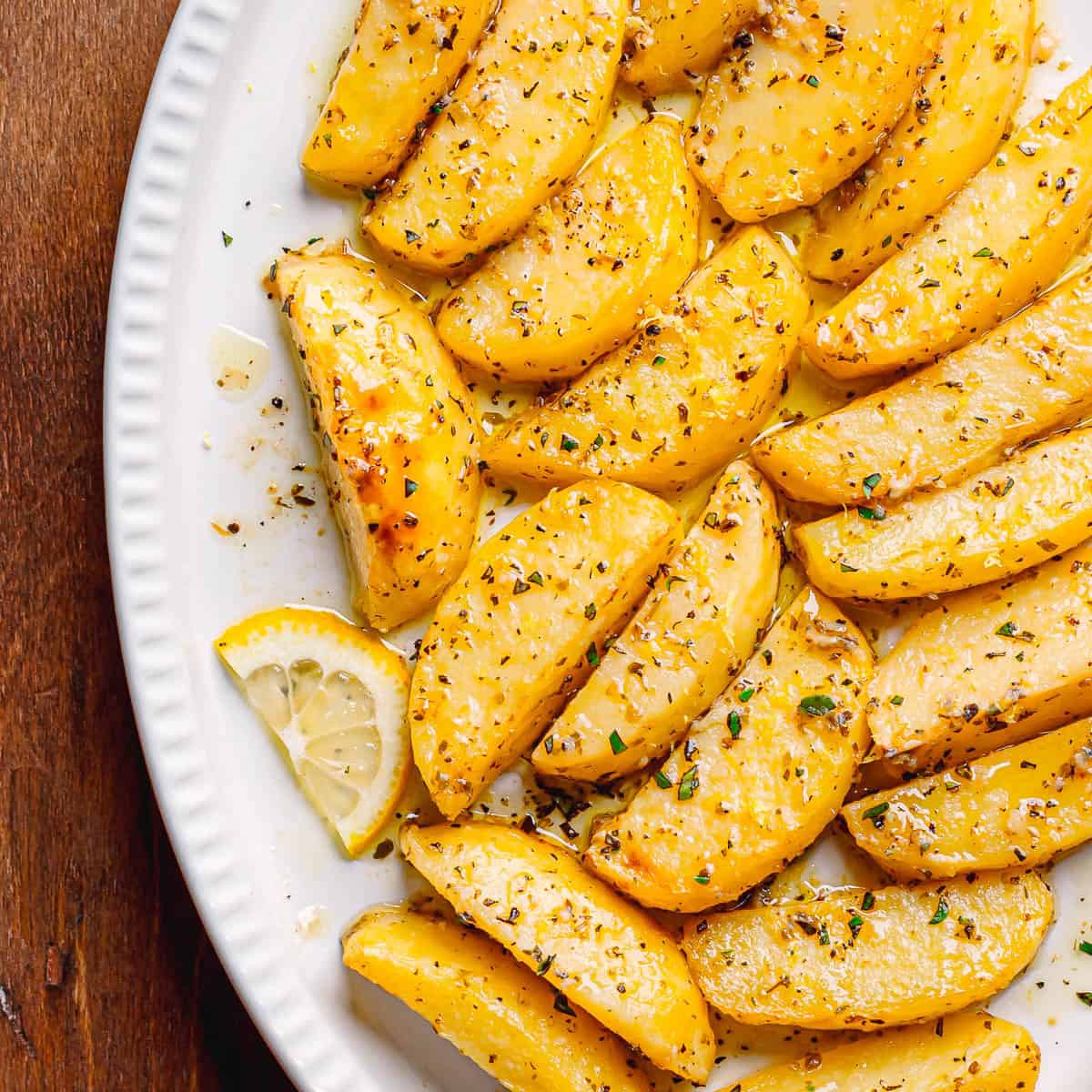 Perfectly roasted Greek Lemon Potatoes just out of the oven, with golden-brown, crispy edges and a glossy lemon glaze. The potatoes are tender inside, slightly caramelized outside, and infused with bright lemon and olive oil aroma a true Greek classic.