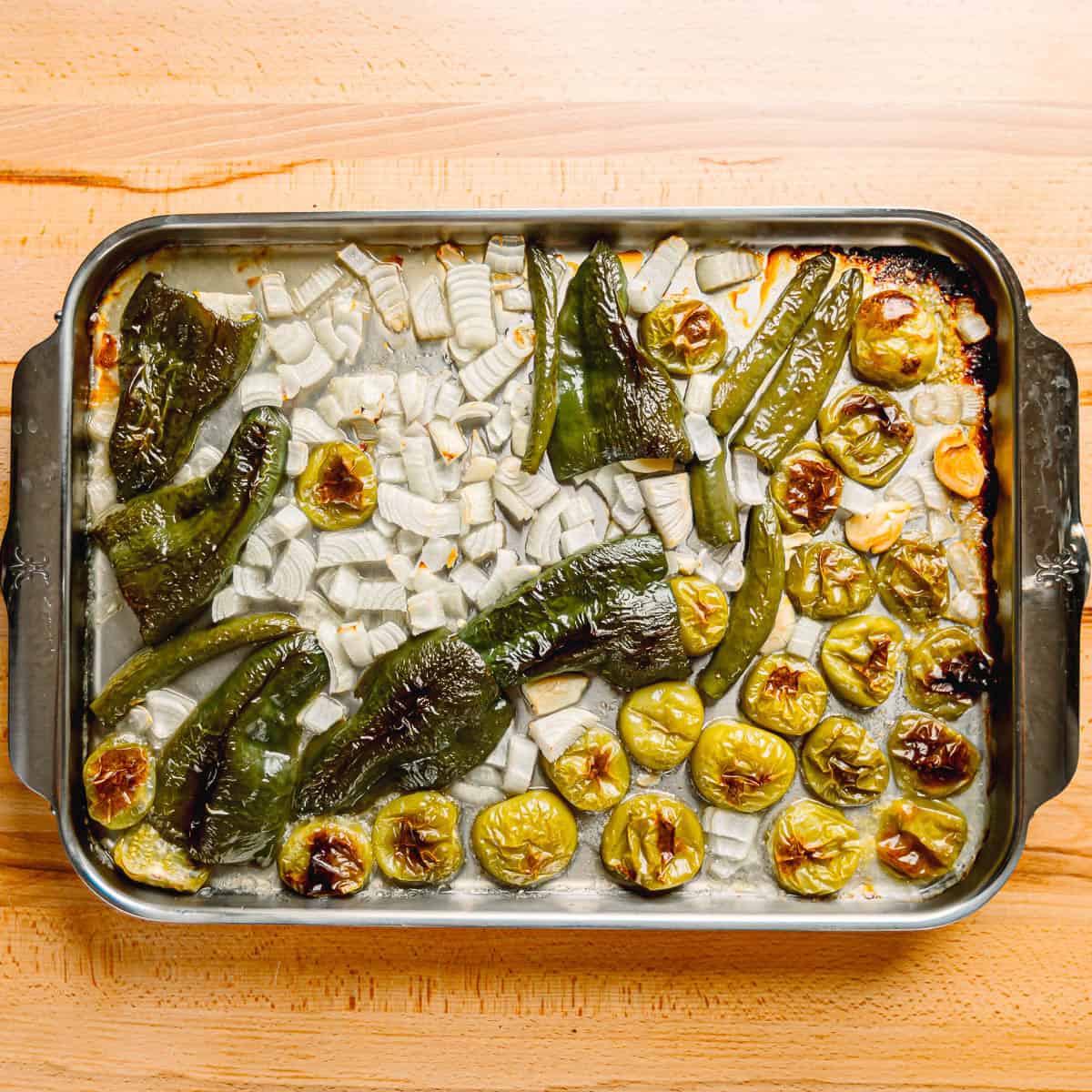 tomatillos, green chilies, onions, and garlic ready to be roasted. 