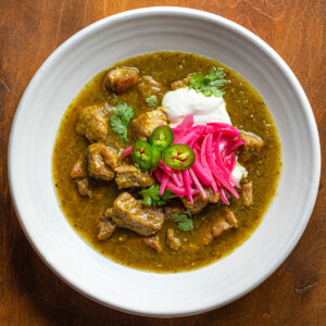 Pork chili verde in a white bowl, ready to eat.