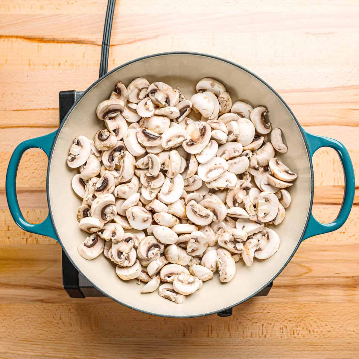 Mushrooms cooking in a dry hot skillet.