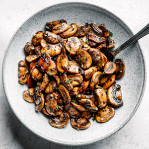 Sautéed mushrooms in a ceramic bowl.