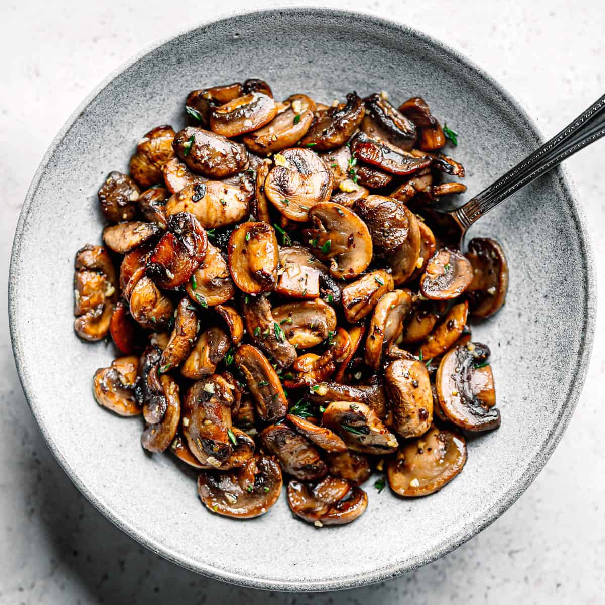Sautéed mushrooms in a ceramic bowl.