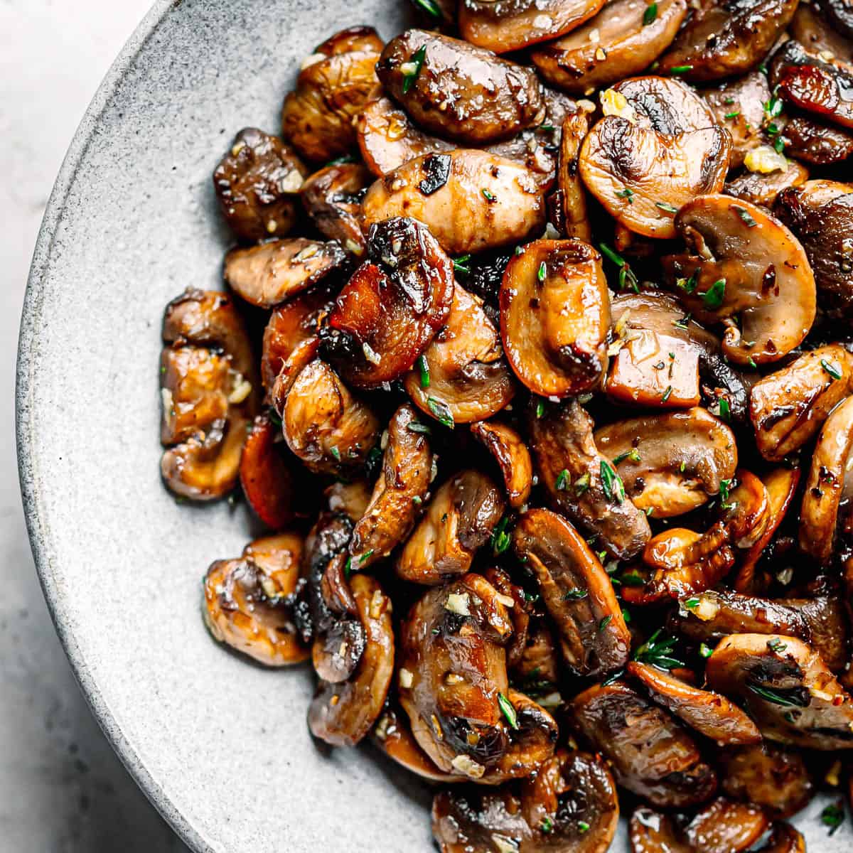 Sautéed mushrooms garnished with thyme.