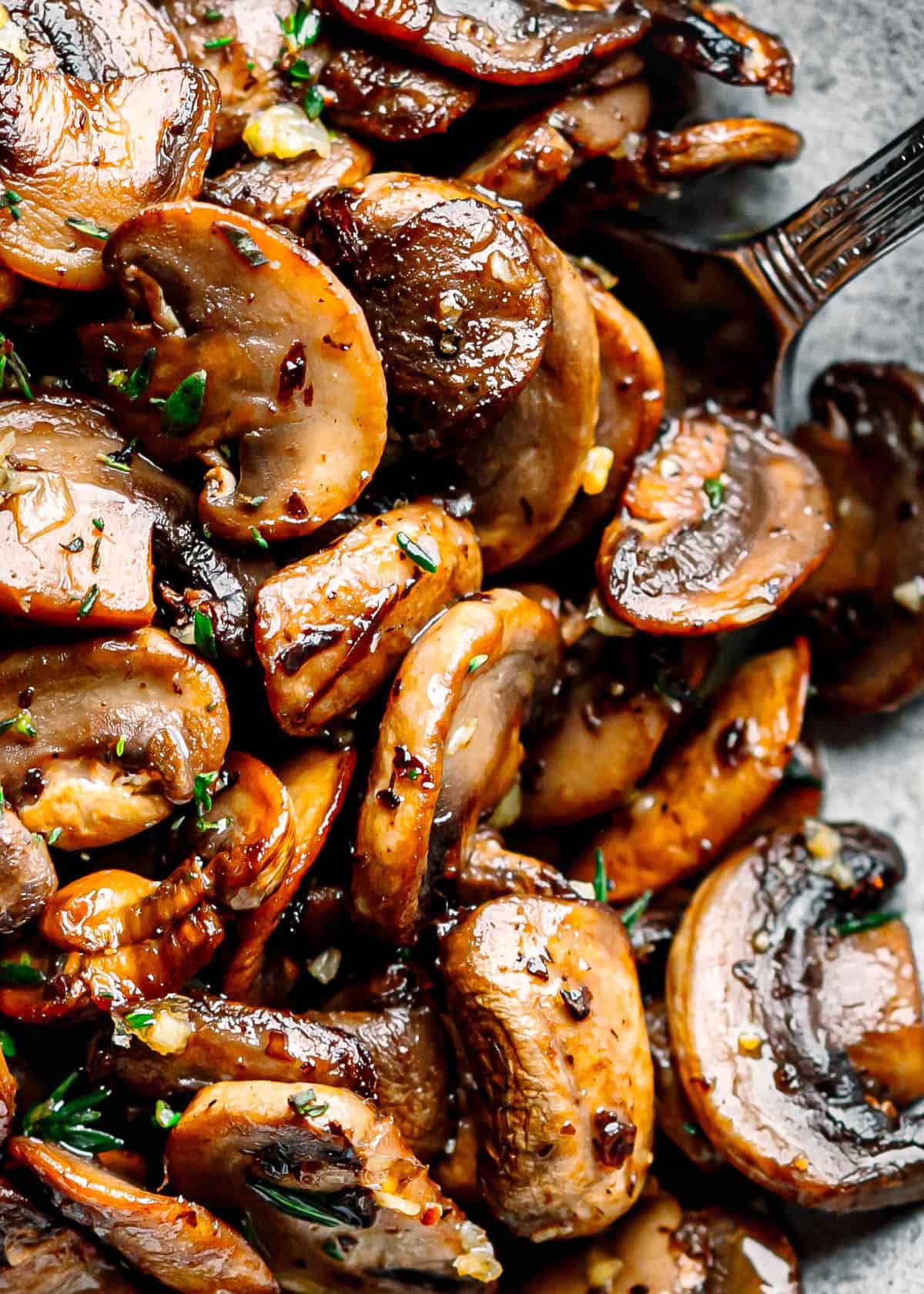 portion of sautéed mushrooms on a serving spoon.
