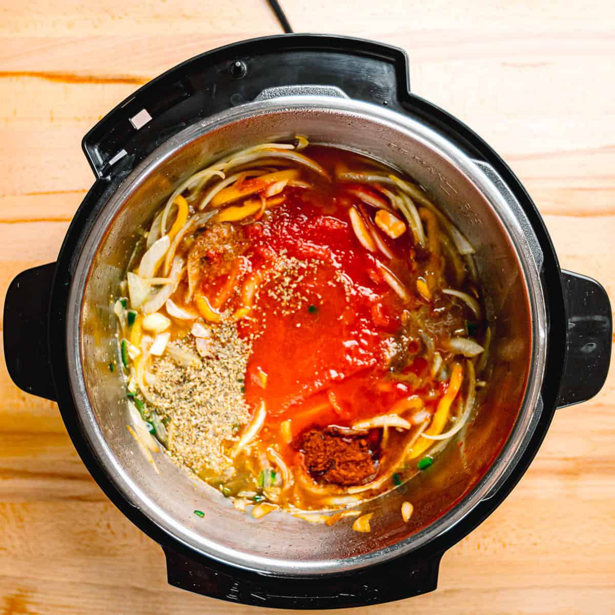Pouring tomato sauce, broth, and white wine into a pot with cooked vegetables.