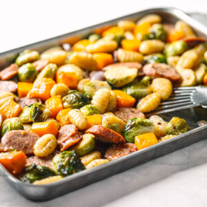 Golden roasted sheet pan chicken sausage with vegetables fresh out of the oven.