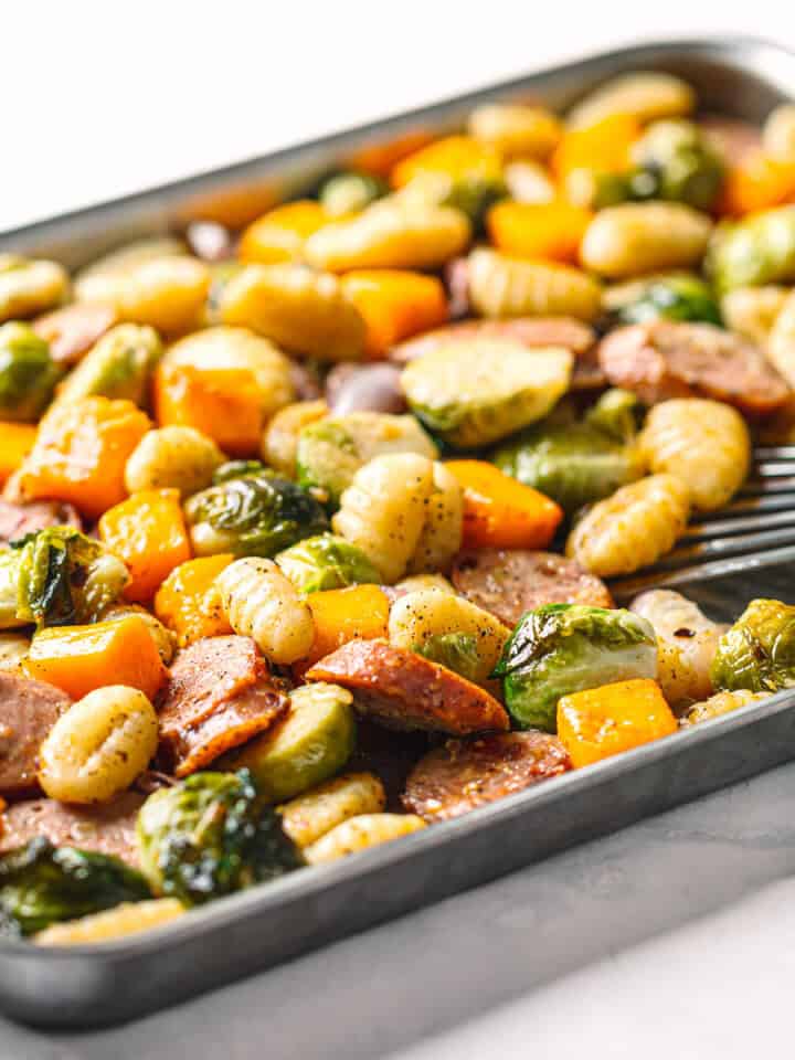 Golden roasted sheet pan chicken sausage with vegetables fresh out of the oven.