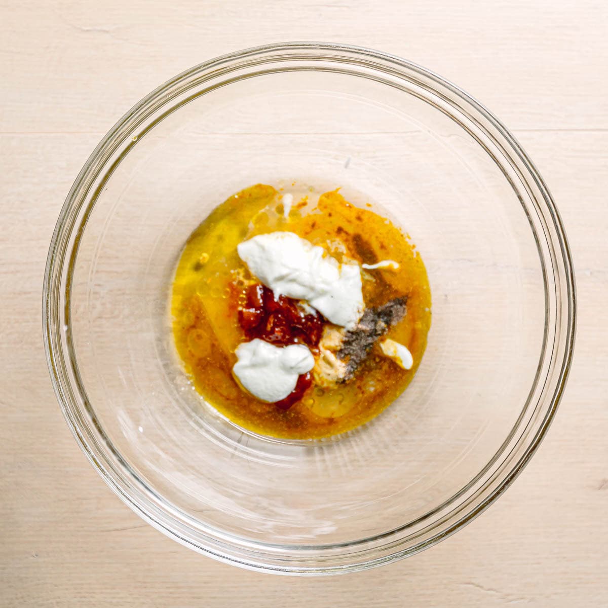 sweet and tangy curry vinaigrette made with mango chutney in a large salad bowl.