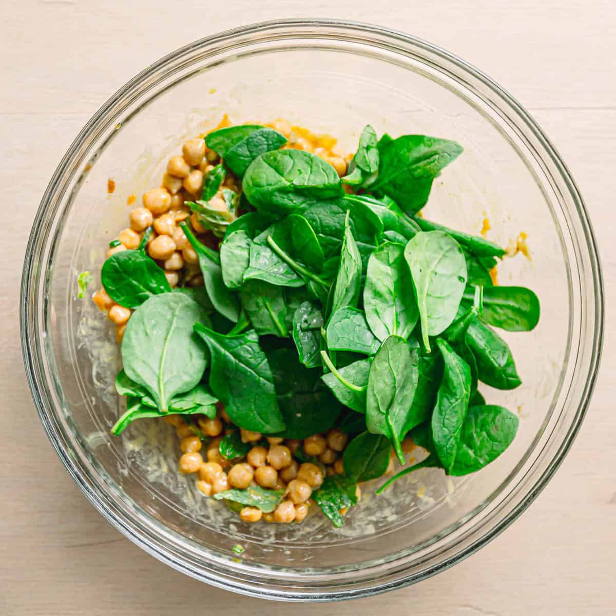 chickpeas, spinach, mint, and green onion tossed together in a large bowl.