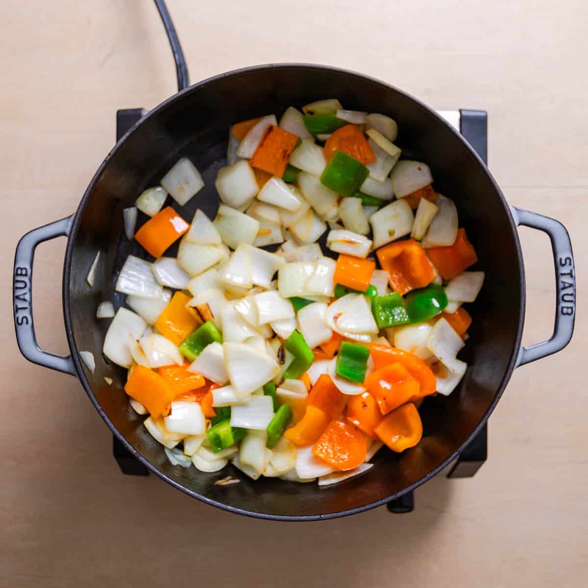 Vegetables charring in skillet for Chicken Jalfrezi.